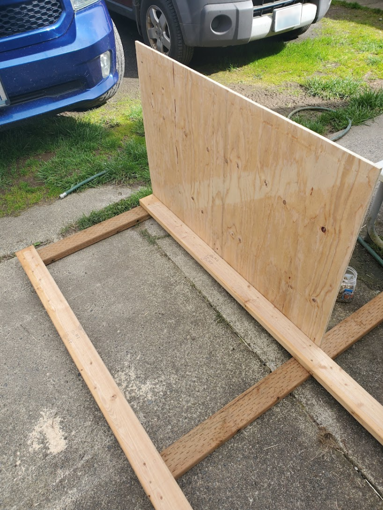 Attaching the bottom panels to the frame while it is on the ground.